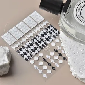 Macro shot of 3D embossed nail stickers with marble diamond patterns and floral designs