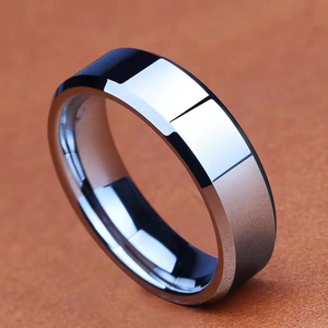 8mm polished black tungsten ring with beveled edges on a brown leather surface