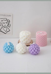Detailed view of colorful geometric pillar candles and bubble candles for home decor
