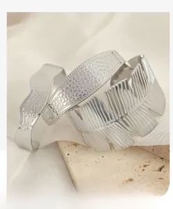 Detailed view of silver textured bracelets set featuring leaf veins and wave patterns