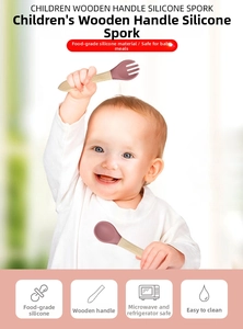 Detail of grey-pink food-grade silicone spoon and fork set with ergonomic wooden handles
