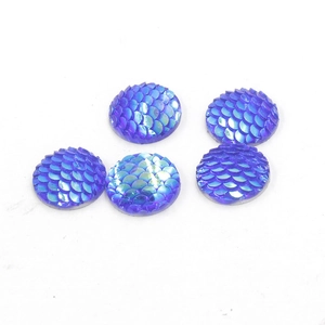 Macro shot of 14mm round resin fish scale cabochons with blue and purple holographic effect