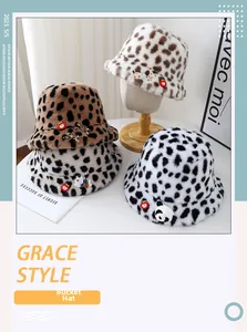 Detail of plush leopard print bucket hats with cute cartoon patches and soft faux fur texture