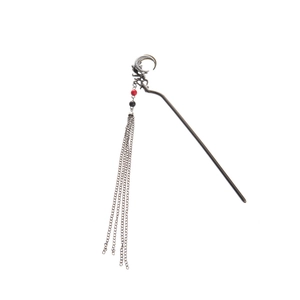 Detail of crescent moon hair stick with gunmetal finish and beaded long tassels