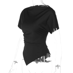 Detail of black slim-fit top featuring asymmetrical hem and ruched waist texture