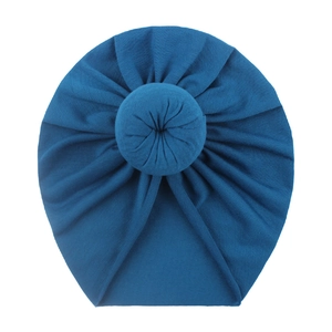 Detail of soft blue knit donut turban hat for babies showing fabric texture and knot