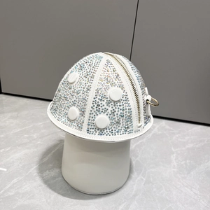 Detail view of mushroom-shaped handbag featuring colorful rhinestones and gold hardware