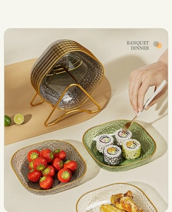 Hammered glass snack plates with gold rims stored in a stylish golden metal rack