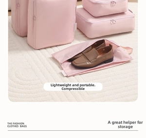 Pink travel luggage organizer set with shoe bag on white textured carpet