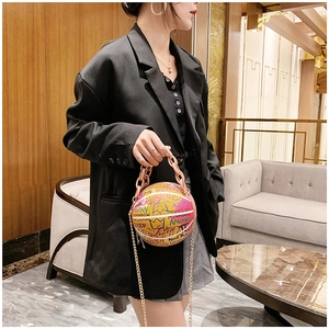 Detail of basketball shaped crossbody bag with colorful graffiti and acrylic chain