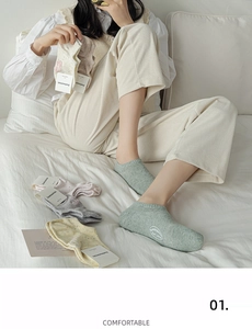 Detail view of colorful low-cut cotton socks in macrame tones with ribbed texture