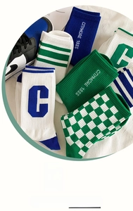 Detail of checkered and striped cotton athletic crew socks with elastic cuffs