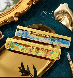 Detail of vintage brass rulers with oil painting cutouts and 10cm metric scales