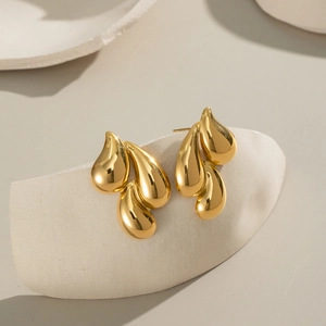 Elegant 18K gold-plated stainless steel teardrop cluster earrings on white stone