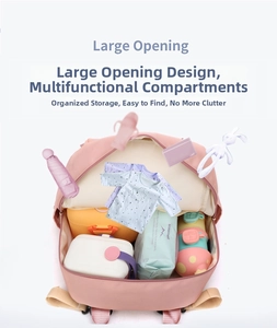 Macro view of pink diaper bag with large opening design and multi-functional compartments