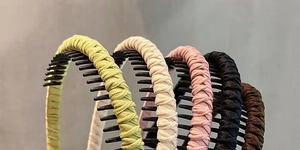 Detail of multi-colored fabric wrapped tooth combs headbands showing anti-slip texture