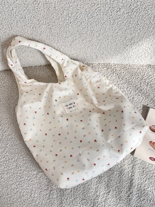 Floral canvas shoulder bag with sweet flower pattern and woven label on beige texture