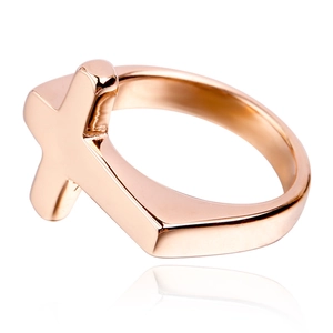 Macro detail of rose gold sideways cross ring with polished mirror finish and sleek design
