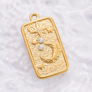 Detail of 18K gold-plated starfish mirror pendant with moon and star relief and zircon