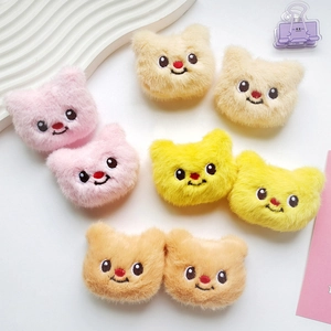 Detail of plush bear doll heads in pink, yellow, and beige for DIY craft accessories