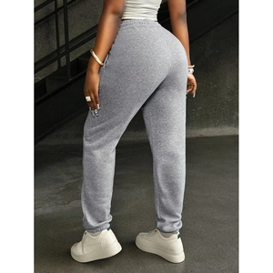 Back view of light grey joggers for women showing the fit and high waist elastic cuff