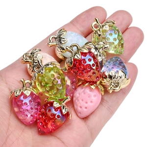 Transparent resin strawberry pendants in assorted colors with gold metal leaf attachments