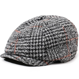 Retro plaid newsboy cap in black and grey with orange stripes shown from a 45-degree angle