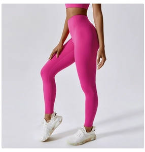 Close-up of high-waist yoga pants in rose red fabric showing seamless texture and fit