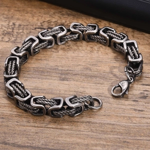 Macro detail of men's stainless steel byzantine cable chain with vintage silver finish