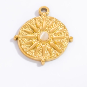 Detail of 18k gold sun pendant with opal stone inlay and hammered metal texture