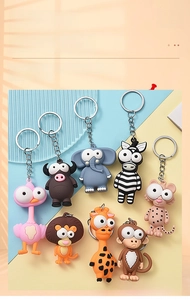 Detailed collection of eight cartoon animal keychains including lion, giraffe and elephant