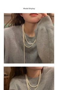 Close-up of a multi-layer long pearl necklace styled on a model with a grey sweatshirt