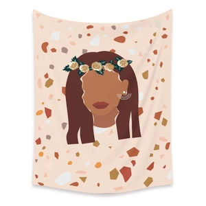 Close-up of bohemian wall tapestry featuring a floral woman silhouette and warm earth tones