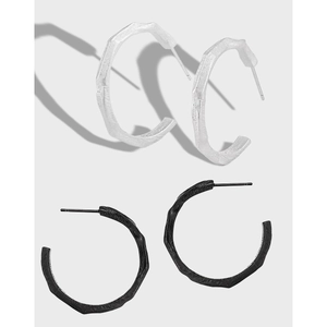 Irregular C-shaped geometric silver and black stud earrings with textured finish