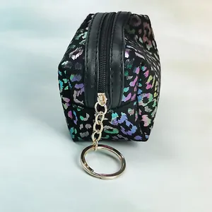 Detail view of colorful laser leopard print mini coin purse with golden key ring