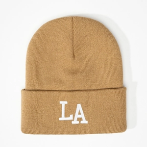 Detailed close-up of camel knit beanie featuring a white 3D embroidered LA logo