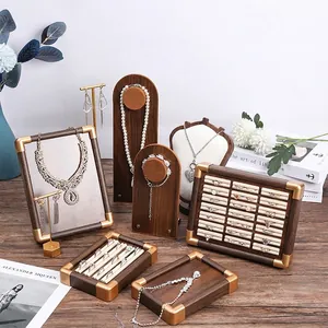 Walnut wood jewelry display set with gold metal accents and soft velvet lining