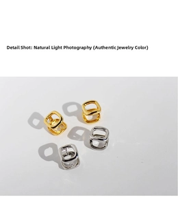 Detail shot of hollow square earrings in gold and silver with polished mirror finish