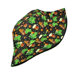 Close-up of Saint Patrick's Day patterns featuring clovers and gold coins on a bucket hat