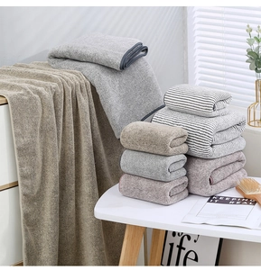 Close-up of fluffy bamboo charcoal coral fleece towels in grey and beige tones