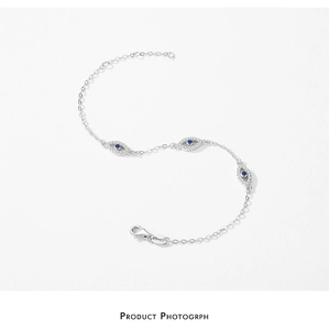 Macro detail of S925 silver Evil Eye bracelet with blue crystal and white cubic zirconia