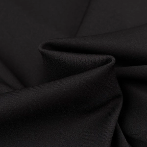 Macro shot of high-quality black knitted fabric texture with elegant draped folds