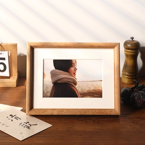 Minimalist solid wood photo frame with white matting and natural wood grain texture