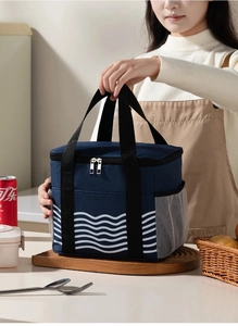 Detail of navy blue wave pattern lunch bag with double handles and side mesh pocket