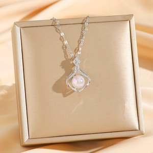 Titanium steel silver teardrop necklace with mermaid pearl on champagne silk background