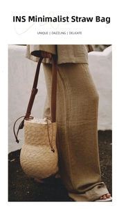Detail of hand-woven straw bag in gourd shape with brown leather straps and drawstring liner