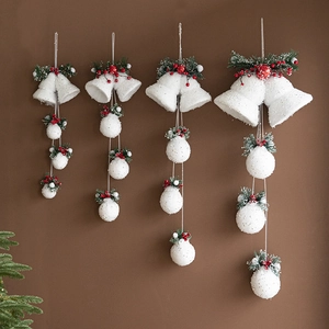 Christmas white glitter bell pendants with red berries and pine needles on brown background