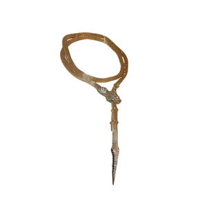 Exaggerated snake-shaped gold tassel necklace with white crystals and green stone eyes
