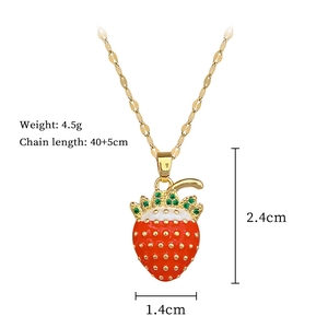 Detail view of a red strawberry pendant necklace with size labels and luxury crystals