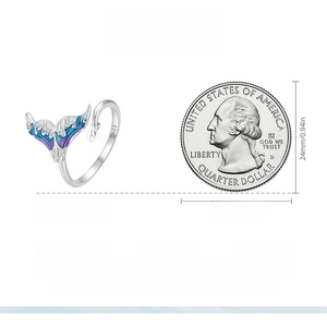 S925 sterling silver mermaid tail ring with blue opal stone next to a US quarter coin